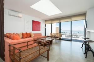 a living room with a couch and a table at Altos de la Gloria Beach Apartments in San Agustin