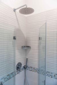 a bathroom with a shower with a glass door at Hotel Acquamarina in Portoferraio