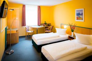 Postel nebo postele na pokoji v ubytování Apart Hotel Weimar