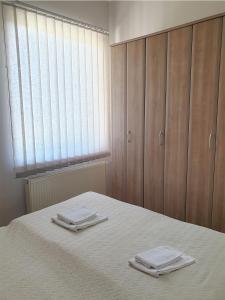 Postel nebo postele na pokoji v ubytování ATRIJUM apartmani Apatin