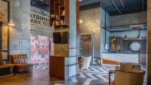 a lobby with a waiting area with a clock on the wall at AYDINBEY PARK OTEL in Konya +14 photos