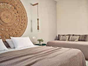 a bedroom with two beds and a chandelier at Casa Del Mar in Laganas +28 photos