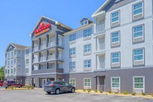 a building with a car parked in front of it at Hawthorn Suites by Wyndham Panama City Beach FL in Panama City Beach