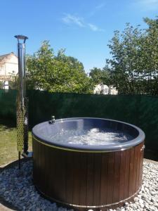 a large hot tub in a yard with a fence at Chata u Horalíků in Humenice
