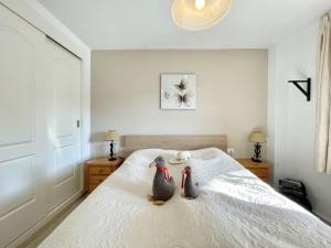 deux pingouins assis sur un lit dans une chambre dans l'établissement Casa Luna Golf Beach Torrequebrada Parking FREE, à Benalmádena 22 autres photos