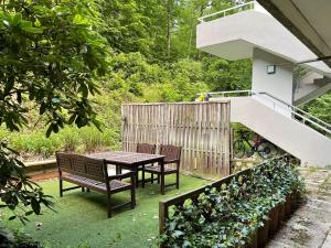 a patio with a table and chairs in a garden at International in Bad Harzburg