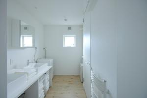 a white bathroom with two sinks and a shower at Nippou no Ie Kamishihoro - Vacation STAY 58990v in Kami-shihoro