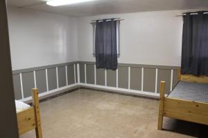 an empty room with two beds and curtains at The Gathering Place in Salina