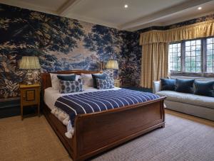 a bedroom with a large bed and a couch at Old Bell Hotel in Malmesbury