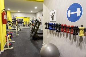 a gym with dumbbells and weights on a wall at Flat no Executive Arrey Hotel in Teresina