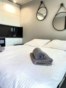 a bedroom with a bed with a towel on it at Apartament Bastion Wałowa in Gdańsk