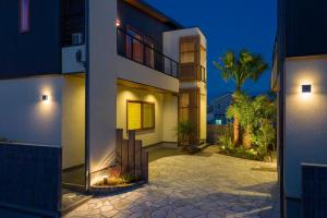 a house with a courtyard at night at J1 wellness - Vacation STAY 62605v in Tateyama