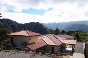 un grupo de casas con montañas en el fondo en Self catering studio by Inn The Coffeepot, en Boquete