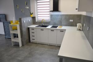 a kitchen with white cabinets and a white counter top at Laba in Jastrzębia Góra