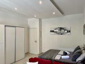 a bedroom with a bed and a red couch at Plaza Teatro & Piazzale Teatro in Rijeka