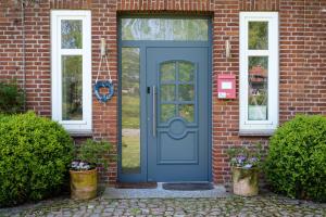 a blue front door of a brick house at Lubblerhof in Fehmarn