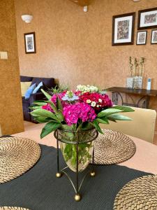 a vase filled with flowers on a table at Dekoratoria Apartments in Krakow