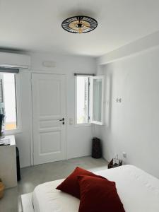 a bedroom with a bed and a clock on the ceiling at Camara Homes in Andros