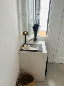 a bathroom with a sink and a window at Camara Homes in Andros