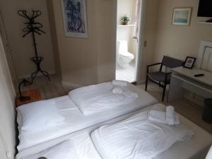 Letto o letti in una camera di Det Gamle Hotel Rudkøbing