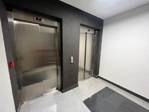 an elevator lobby with two elevators in a building at NewFormula in Sarajevo