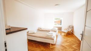 a room with a bed and a chair in it at Byggmästare Villan in Motala