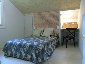 a bedroom with a bed and a table with a chair at Hotel Bruselas in A Guarda