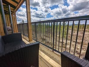 a porch with two chairs and a view of the beach at Poolorama Lodge - with magnificent mountain view in Idre