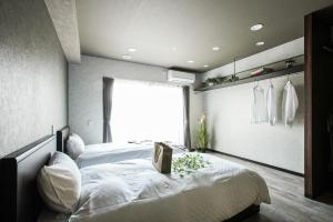 a bedroom with a large bed and a window at VACATION RENT Kanazawa - Vacation STAY 69560v in Kanazawa