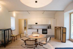 a kitchen and dining room with a table and chairs at Haflingerstall in Neudiehman