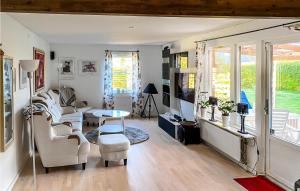 een woonkamer met witte meubels en een tafel bij Awesome Home In karp With Kitchen in Åkarp
