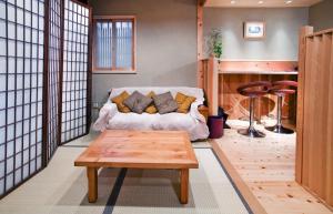 a living room with a couch and a coffee table at Kyomachiya Amanogawa - Vacation STAY 69288v in Kyoto