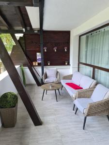 a balcony with chairs and a table and a window at Relax Apartment Predeal in Predeal