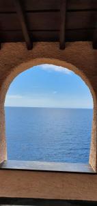 a view of the ocean through a stone window at A Ca Mè in Bonassola