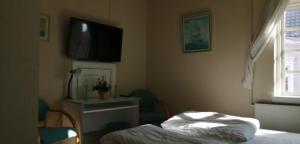 Letto o letti in una camera di Det Gamle Hotel Rudkøbing