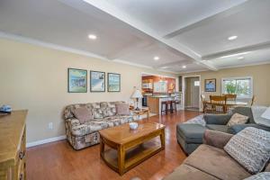 a living room with couches and a table at Pleasant Street Retreat in Boyne City