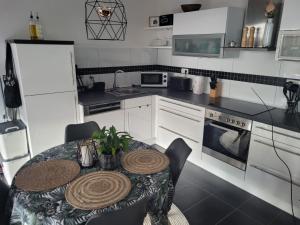 a kitchen with a table and a kitchen with white appliances at "Loft" in Wolfenbüttel in Wolfenbüttel