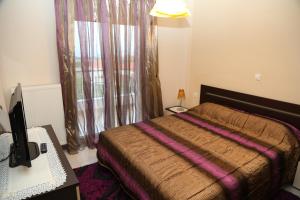 Ένα ή περισσότερα κρεβάτια σε δωμάτιο στο Villa Olympus