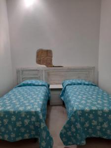 Cama o camas de una habitación en Appartamento su palazzina storica in centro a Sant'Antioco