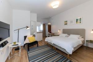 a bedroom with a bed and a desk and a chair at Villa Feral Apartments in Crikvenica