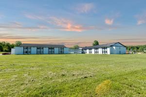 a large field in front of a building at Days Inn by Wyndham Erie in Erie