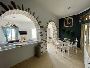 a kitchen and living room with a table and chairs at Dionysos Sea and Stone Luxury Villa in Kardiani