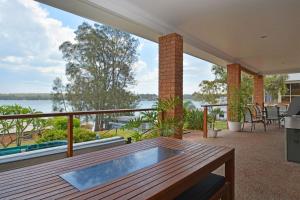 a patio with a table and a view of the water at Fishing Point Shores in Fishing Point