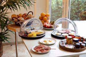 a breakfast table with breakfast foods on a counter at B&B Lobelia-Brugge in Bruges