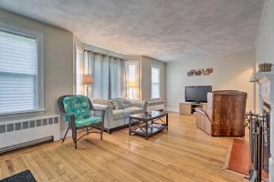 a living room with a couch and a tv at Cozy Middletown Home Near Beaches and Newport! in Middletown