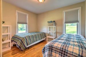 a bedroom with two beds and two windows at Cozy Middletown Home Near Beaches and Newport! in Middletown