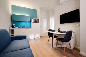 a living room with a couch and a table with chairs at DONATELLO11 Milan apartments in Milan