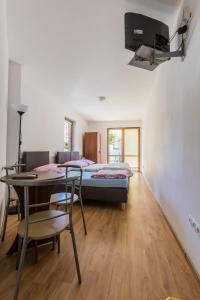 a bedroom with a bed and a table and a bed at Willa Mila in Trzęsacz