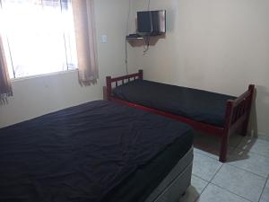A bed or beds in a room at 261 - Casa de Praia Armacao de Itapocoroi