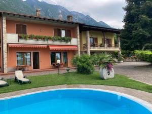 a house with a swimming pool in front of a house at Apartments Panoramica in Malcesine